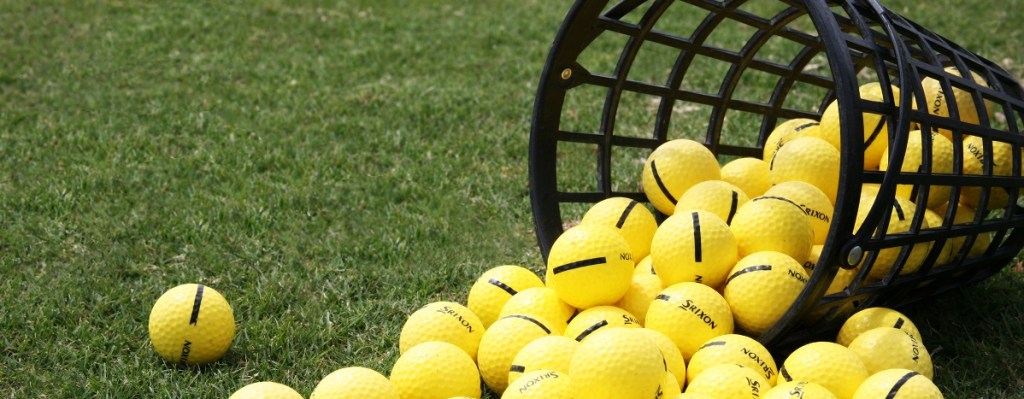 basket of golf ball spilling on the grass